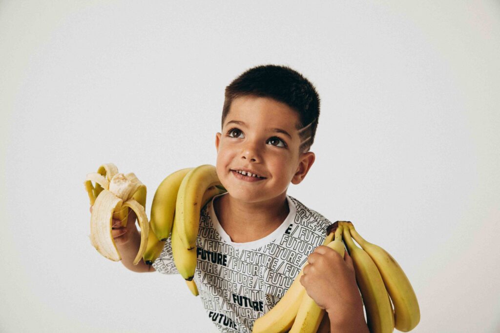 QA BOY HOLDING LOTS OF BANANA