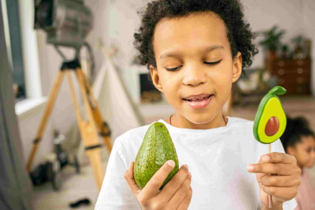 BOY HOLDING AVOCADOS